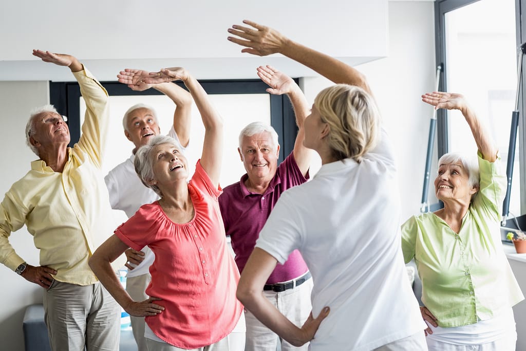 Senior citizens in a stretch class
